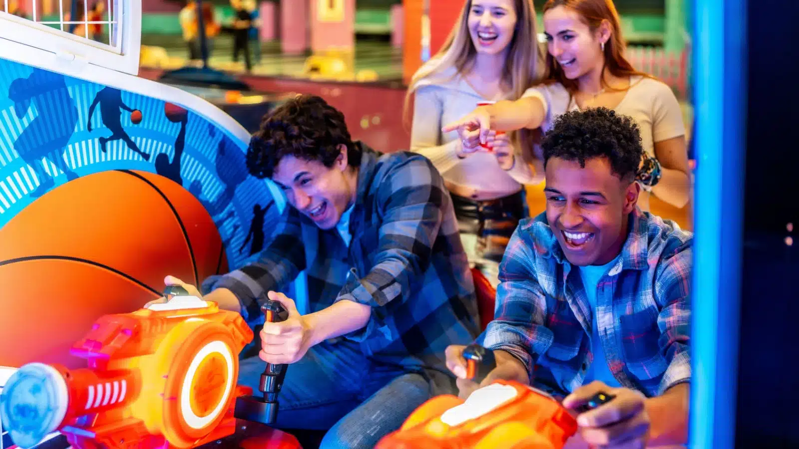 A group of friends playing games at an arcade.