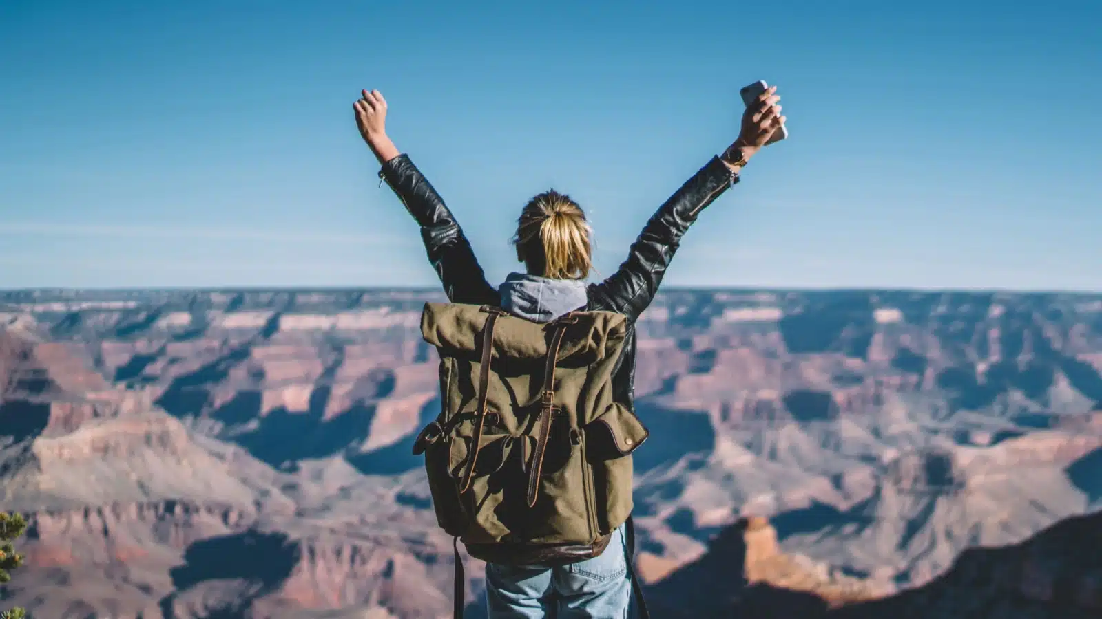 A tourist enjoying the views at the Grand Canyon.