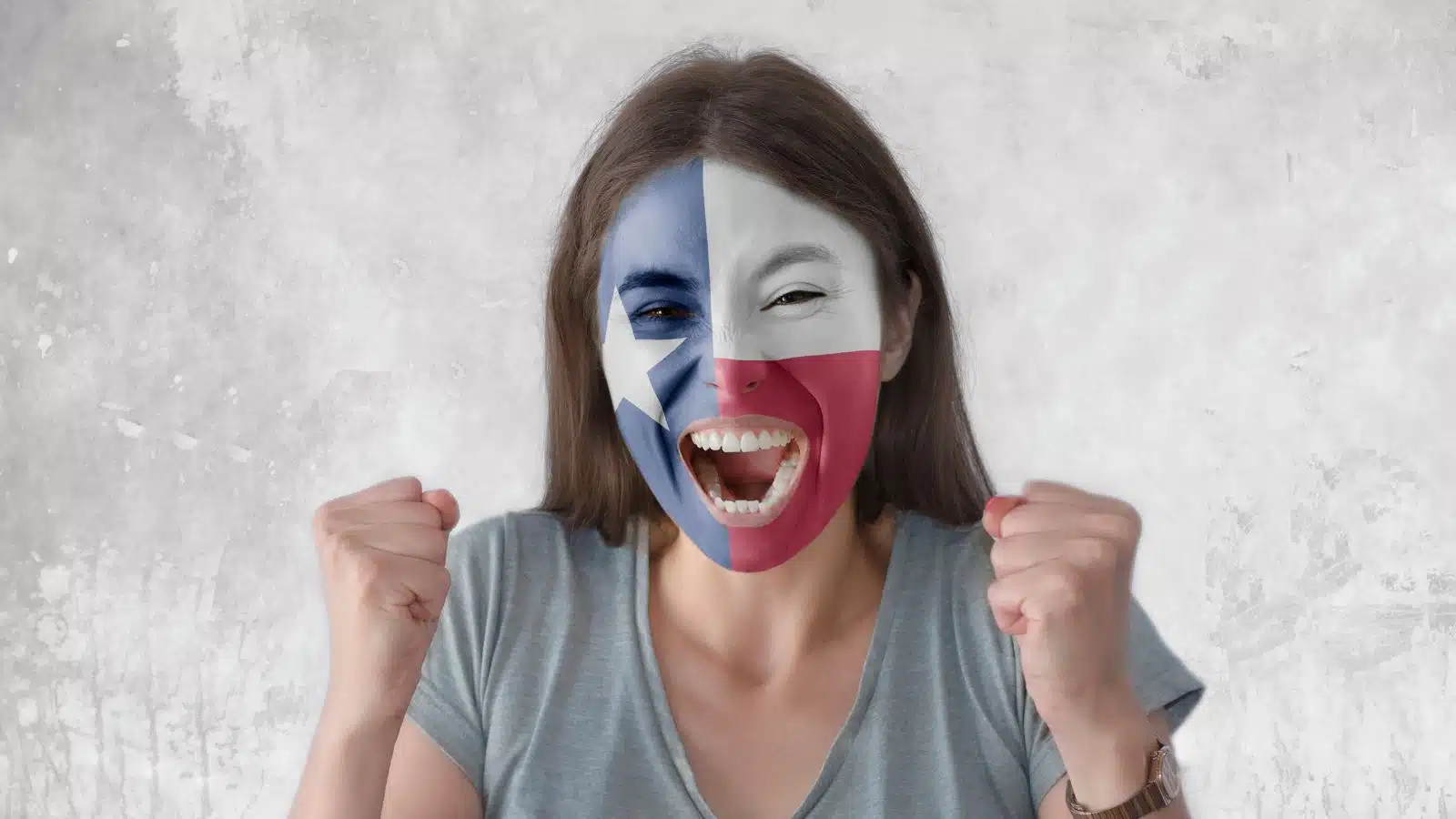 A proud woman celebrates with her face painted to represent the Texan flag.