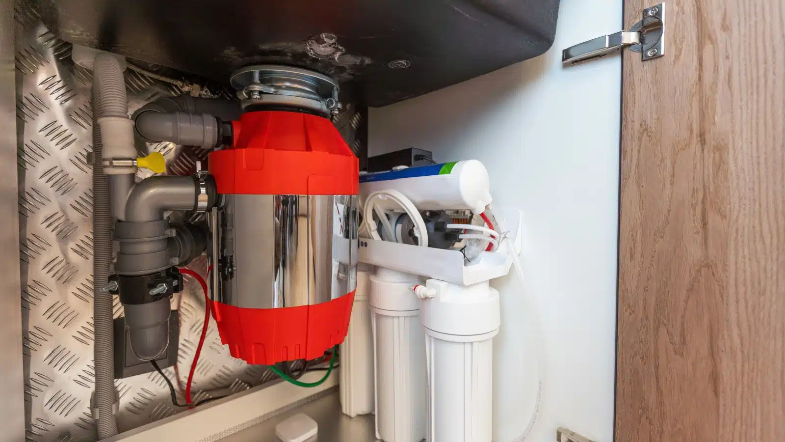 A garbage disposal unit under the kitchen sink.