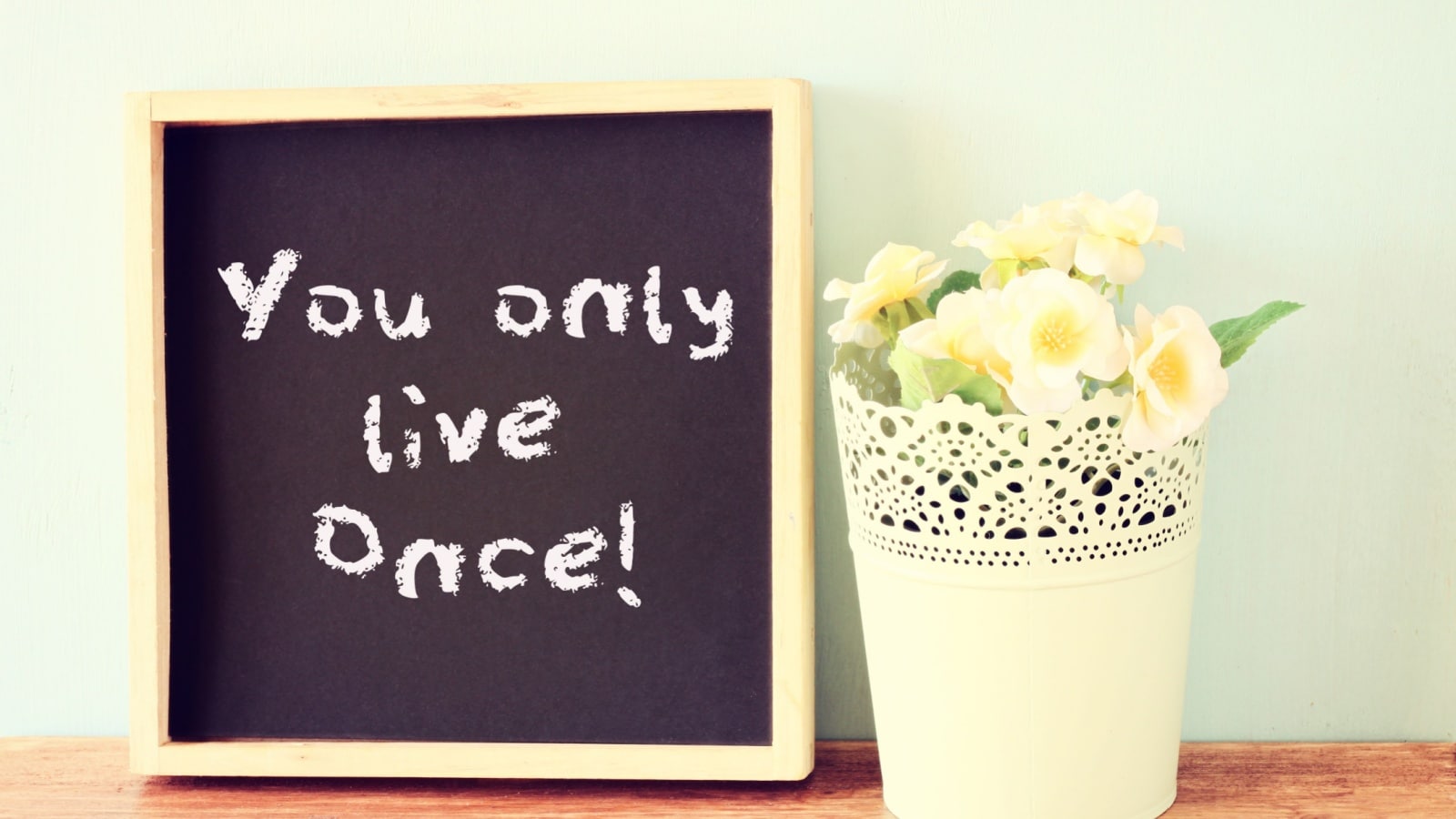 A little chalkboard says "you only live once," to represent the best life quotes.
