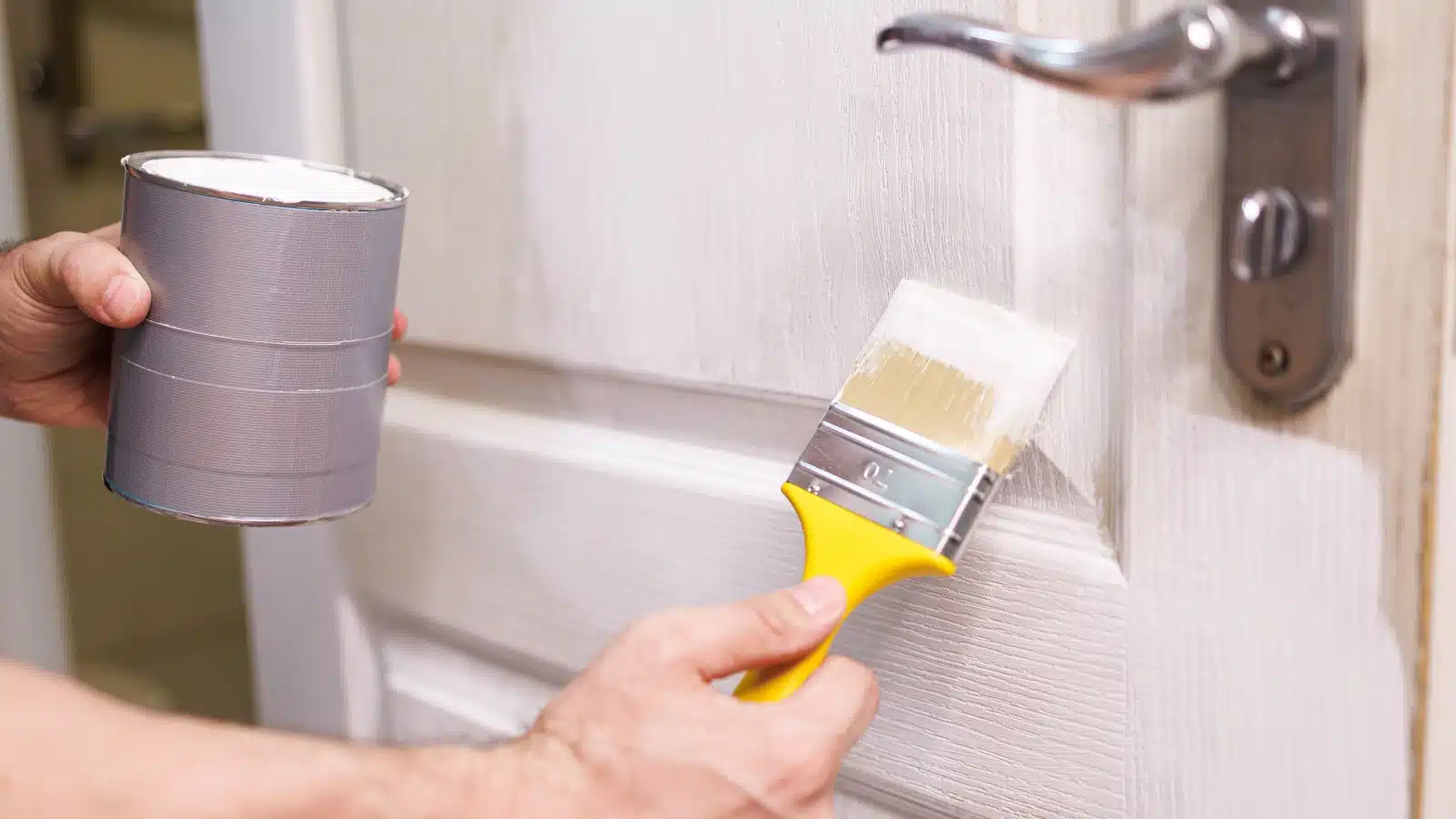 Painting an older door white.