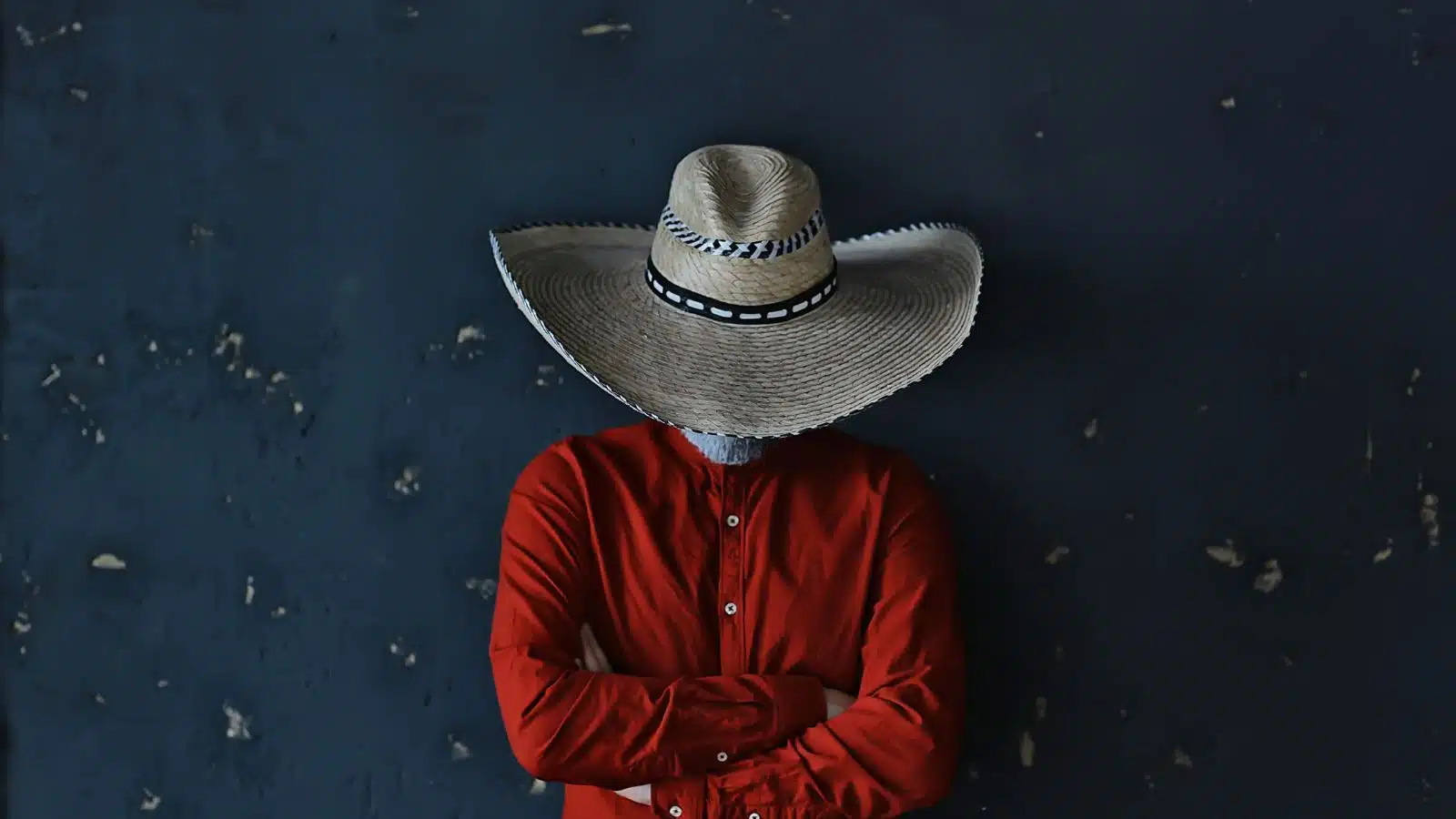 An angry cowboy with his head down, hat covering his face, represents why everyone hates Texas.