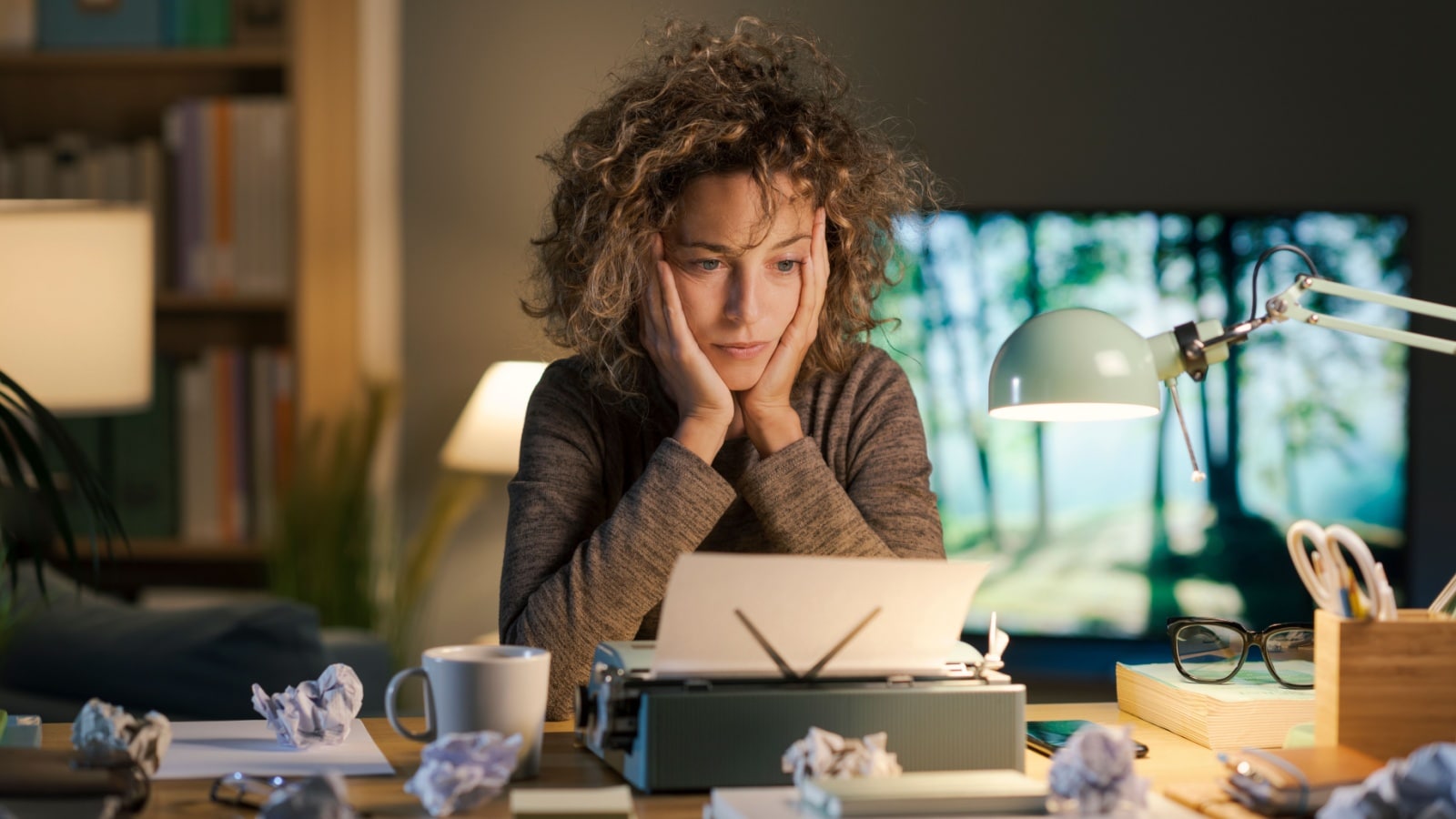 A frustrated woman struggles with writer's block, showcasing the need for writing prompts.