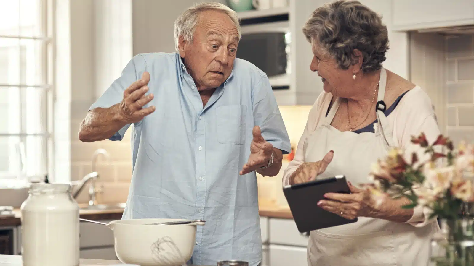 A clueless man needs step by step directions from his wife in the kitchen. It looks like he's practicing weaponized incompetence.