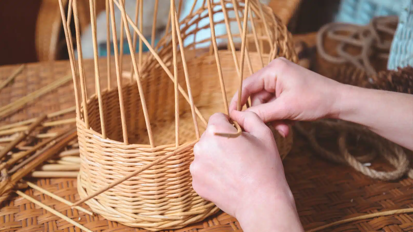 A woman hand weaves a basket as a hobby.