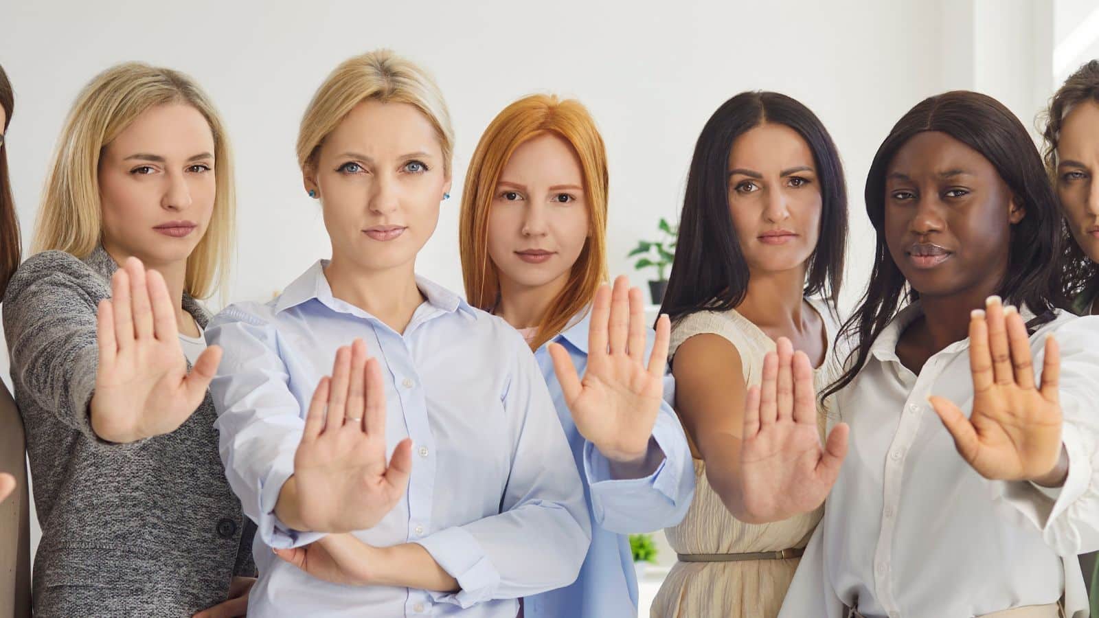 A group of women holding their hands out as if to say "no" to represent behaviors everyone calls rude that aren't actually rude.