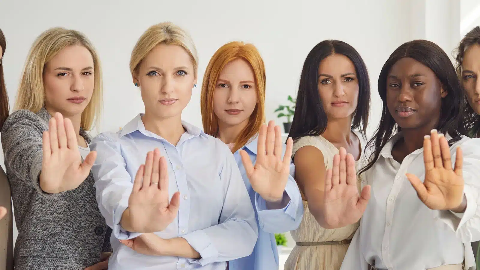 A group of women holding their hands out as if to say "no" to represent behaviors everyone calls rude that aren't actually rude.