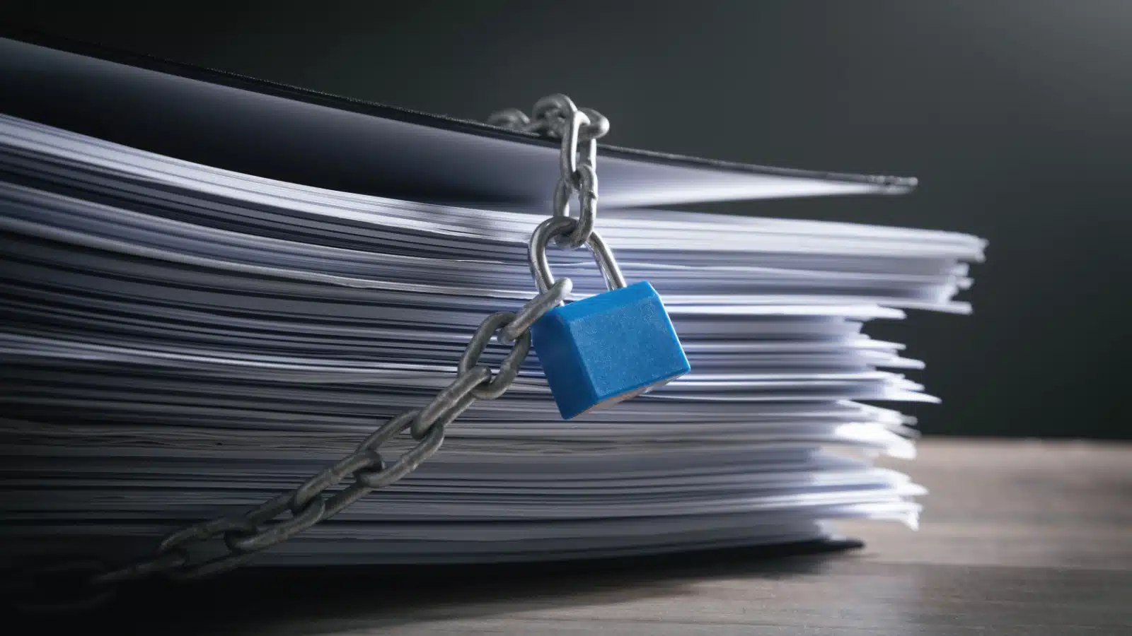 A stack of documents locked up to show they are confidential.