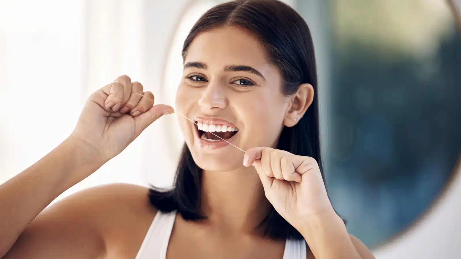 A woman flossing.