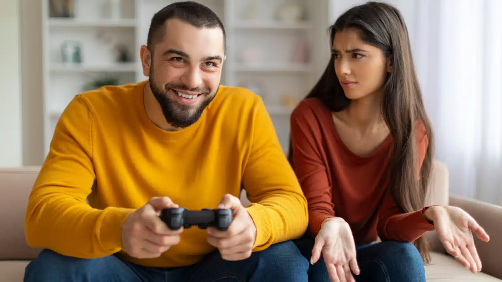 A woman is angry that her boyfriend won't stop playing a video game.