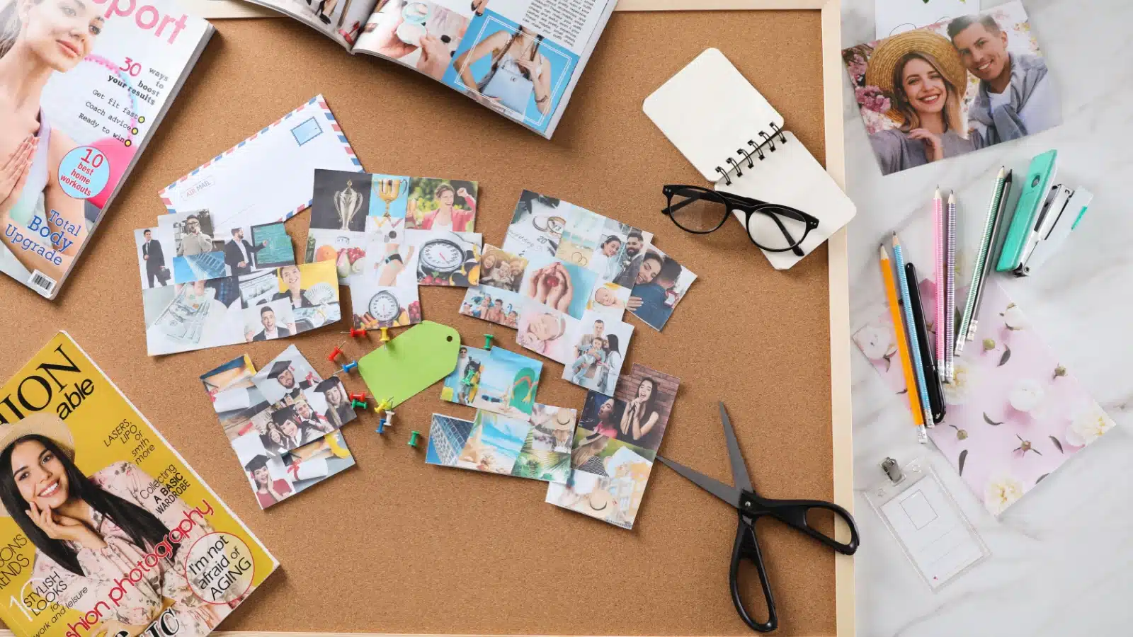 Making a vision board on cork, surrounded by magazines, represents vision board ideas.