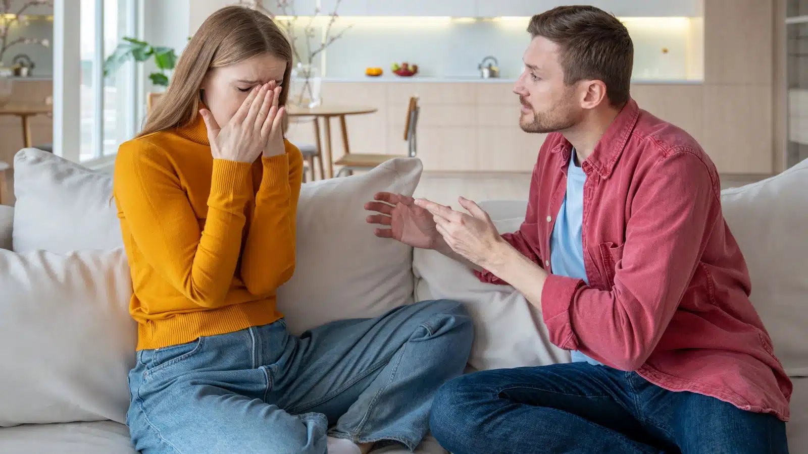 A man argues with his crying girlfriend to represent common manipulation tactics men use to get what they want in relationships.