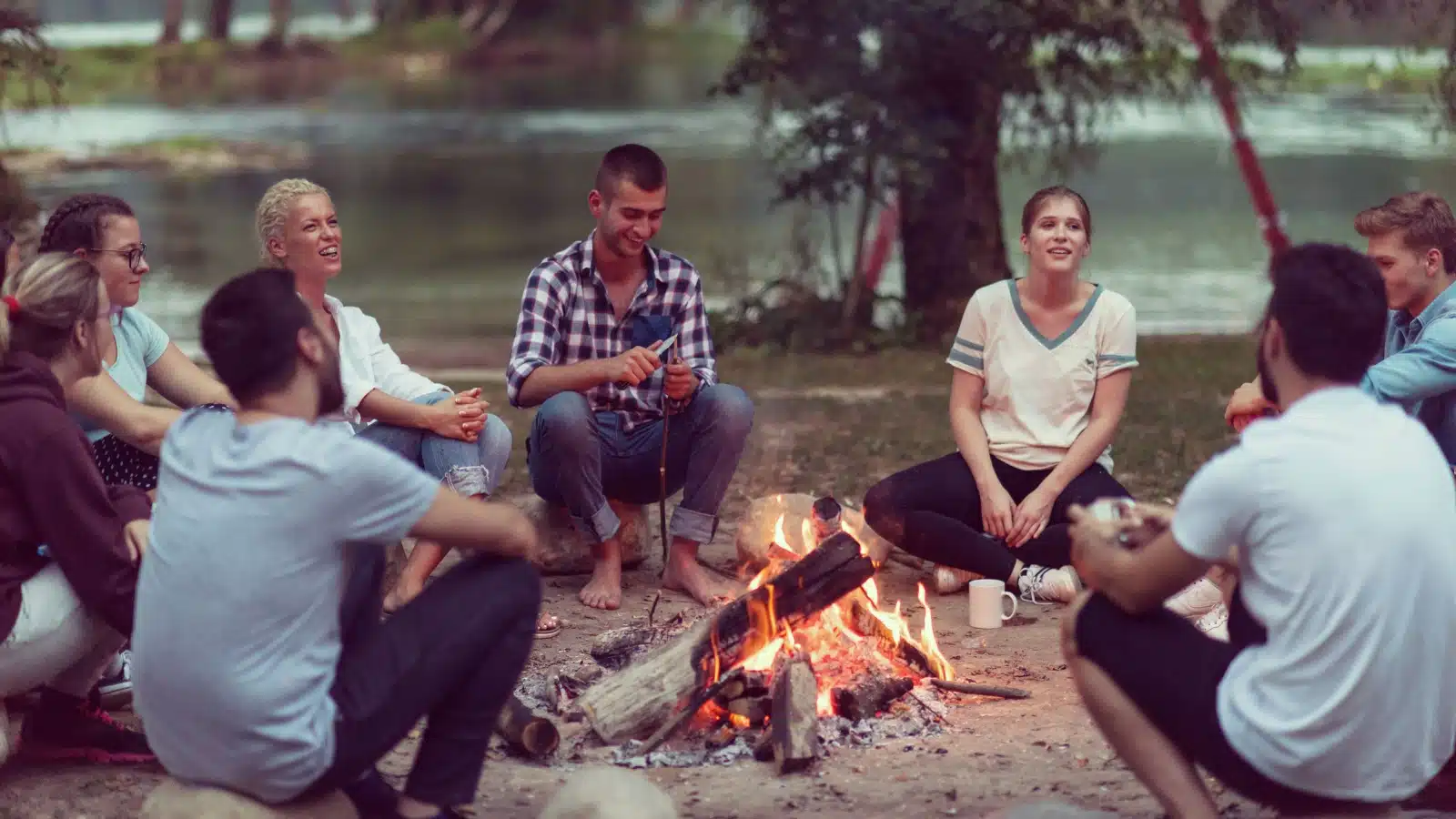 A group of friends sitting around a campfire sharing stories. 