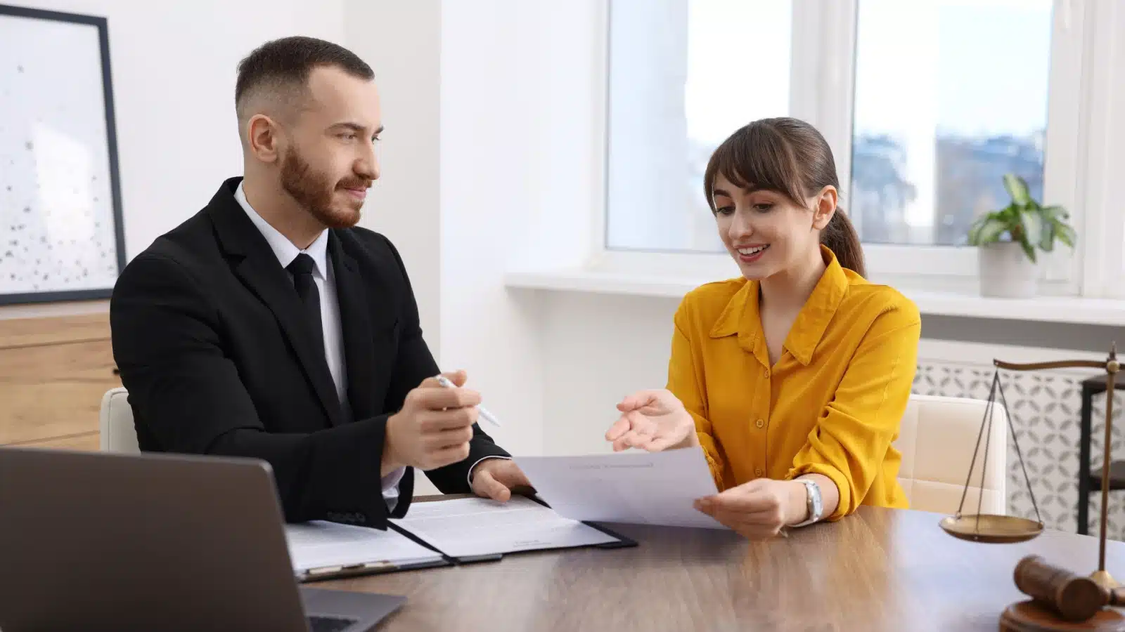 A happy woman meets with her lawyer.