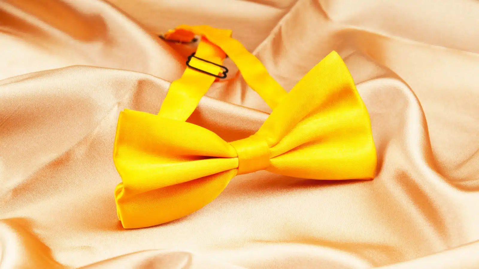 A yellow ribbon tied into a bow. 