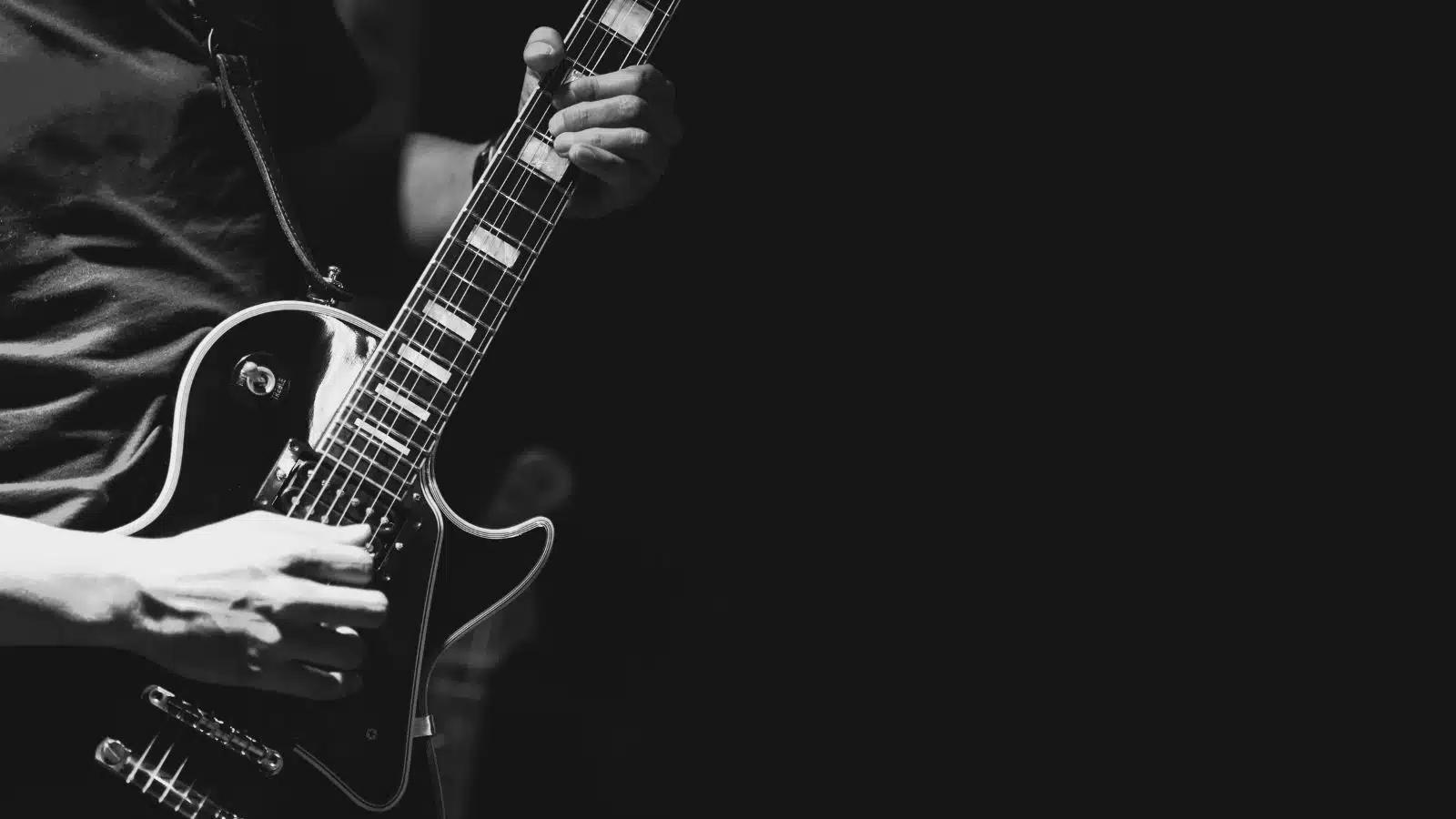 Black & White image of a guitarist playing the blues.