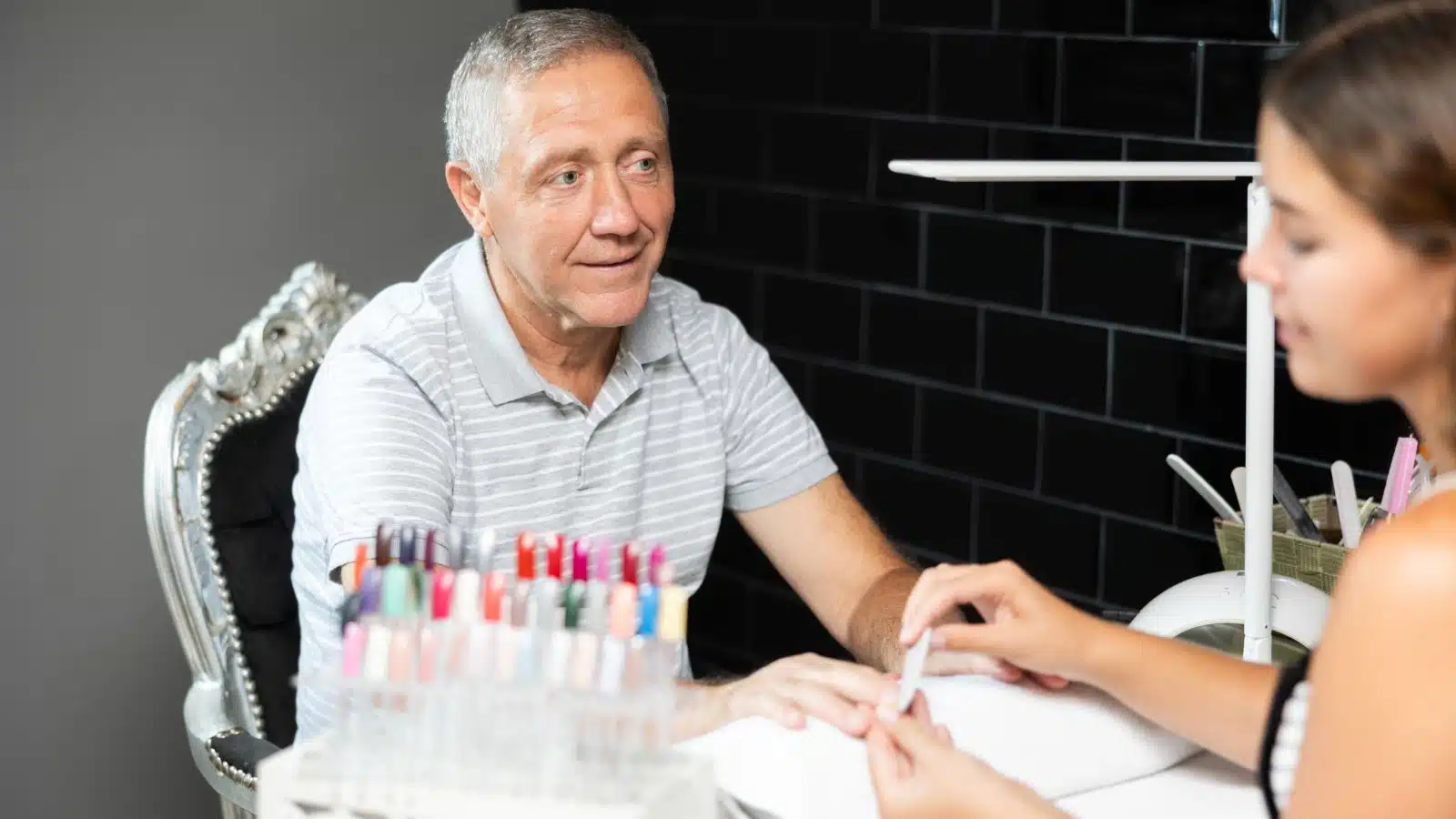 A man enjoys a manicure.