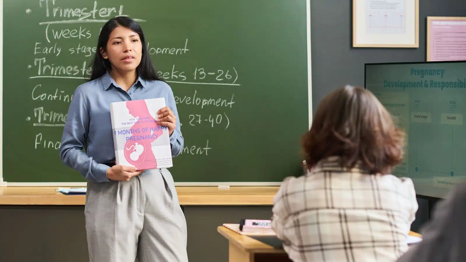 A woman teaches a class about pregnancy.