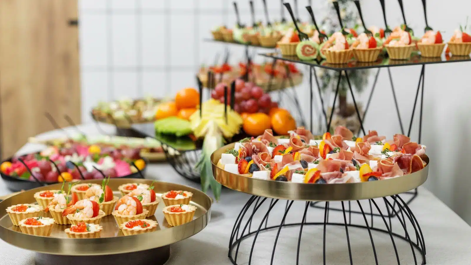 An assortment of fancy finger foods on a catering table.