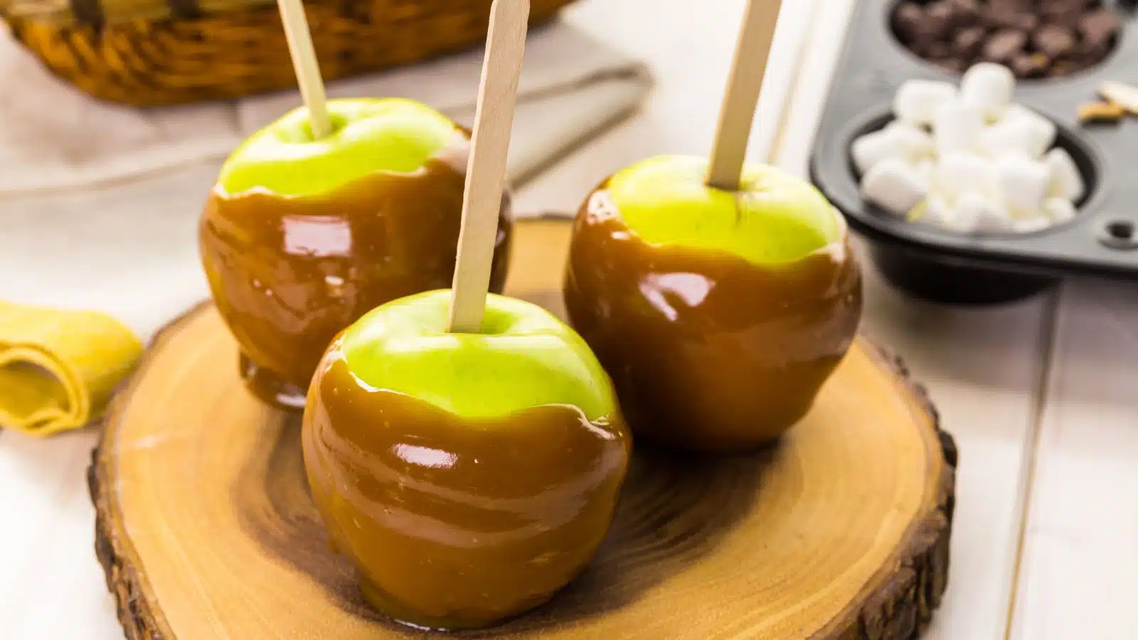 Three fresh candied apples dripping with caramel.