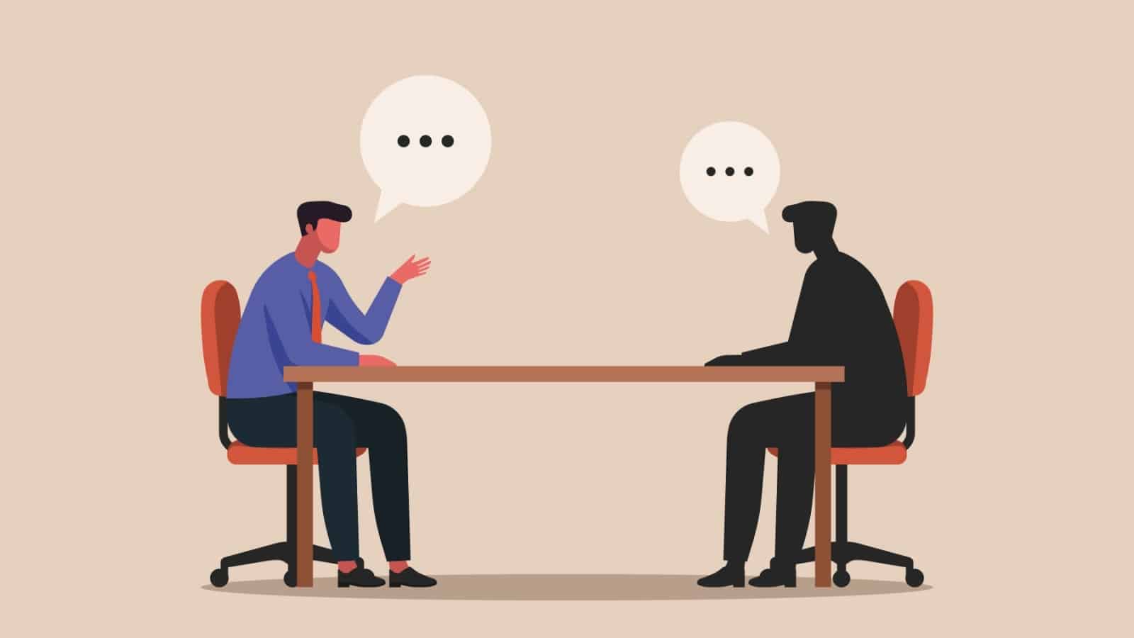 A man sits at a table, conversing with his shadow self, to represent how to do shadow work.