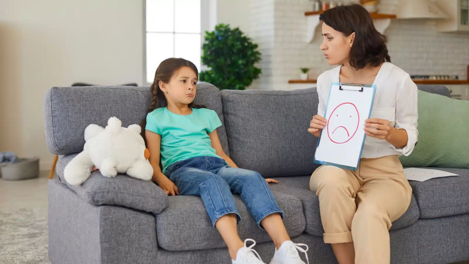 A therapist teaching a child how to manage their emotions.