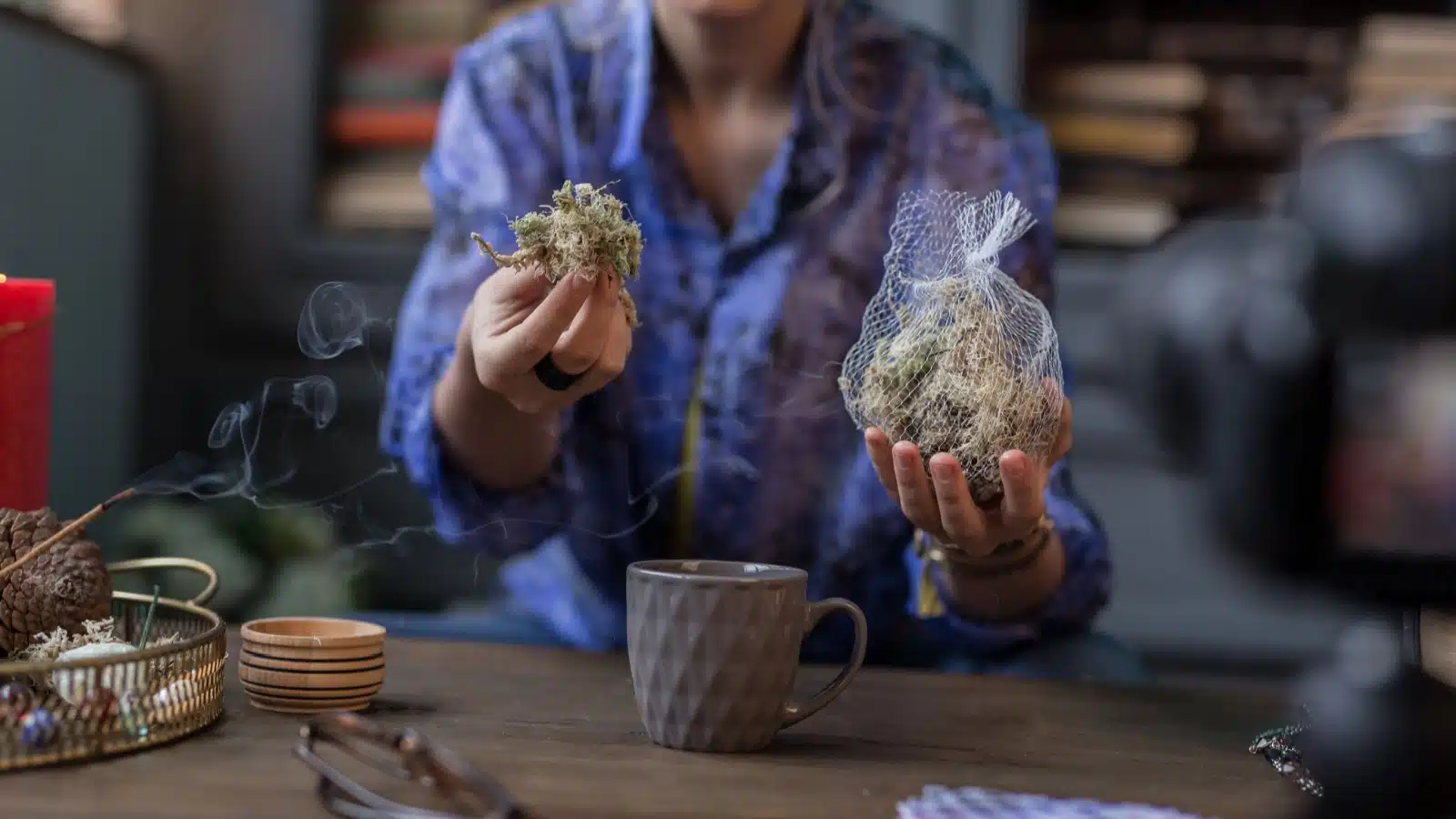 A modern witch casting a spell with herbs and tea.