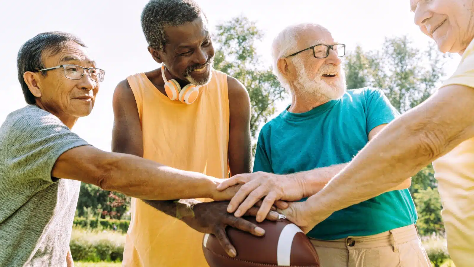 A group of older men playing flag football together.