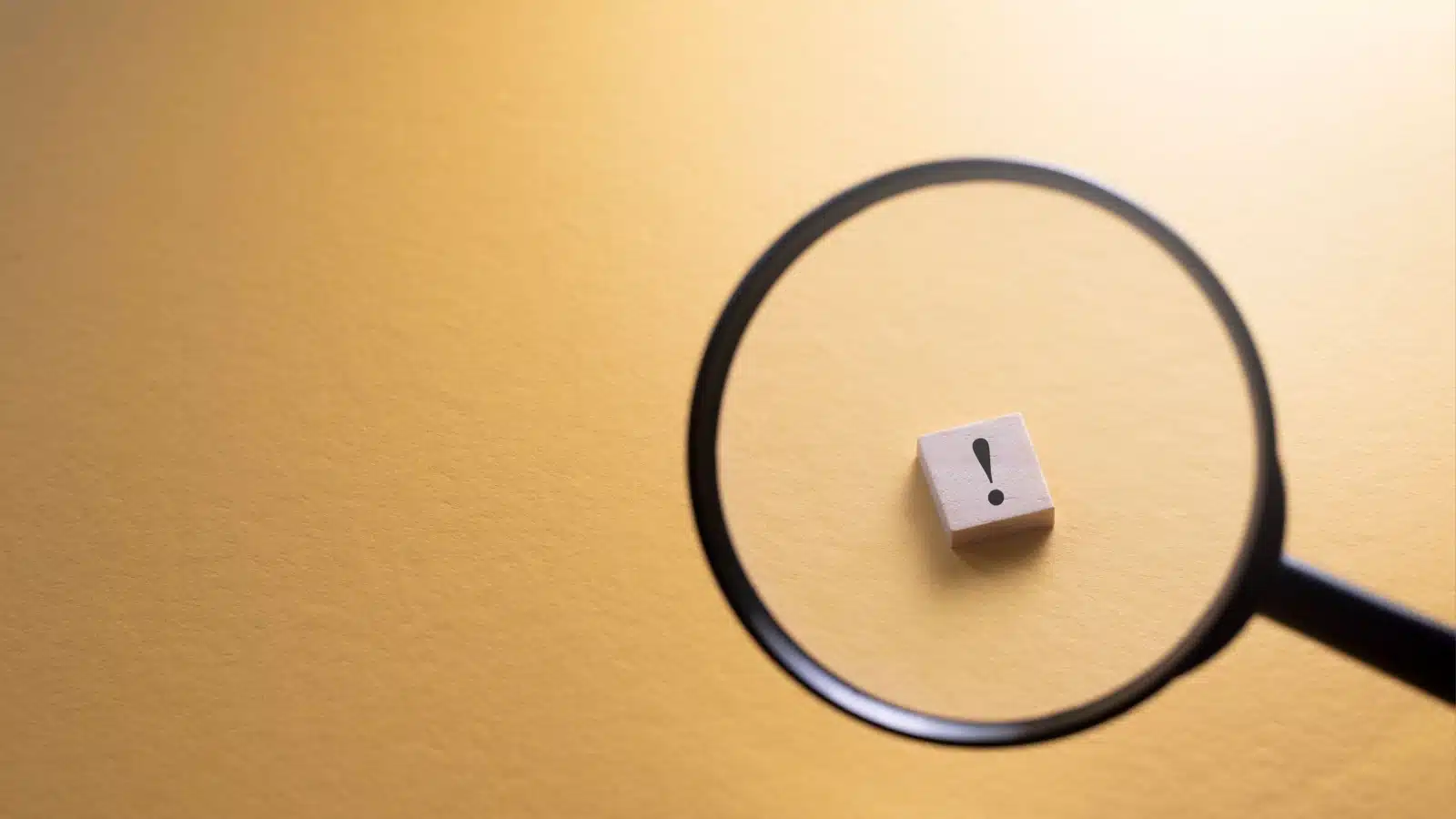 A magnifying glass focused on an exclamation point.