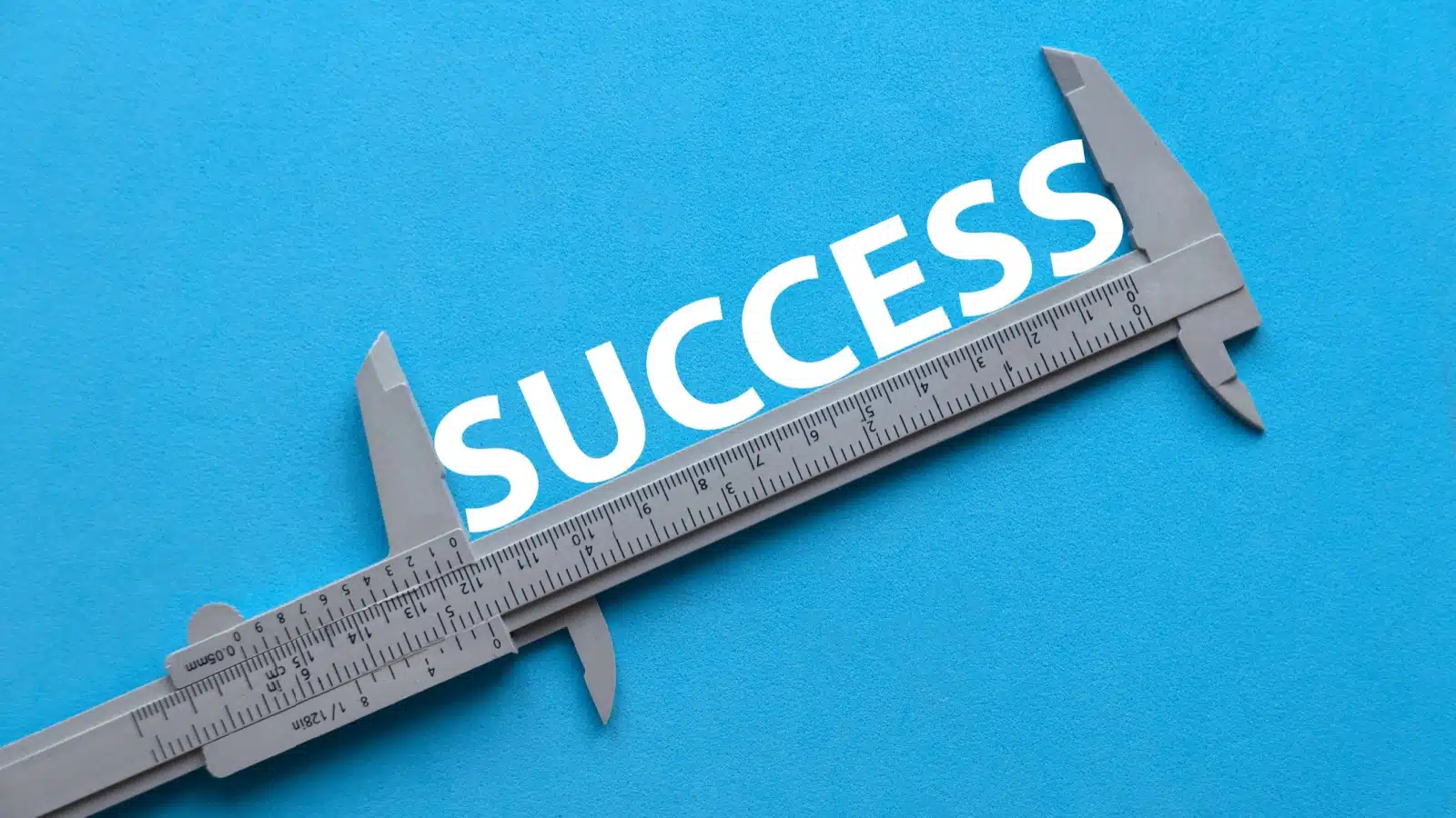 A ruler measuring the word success.
