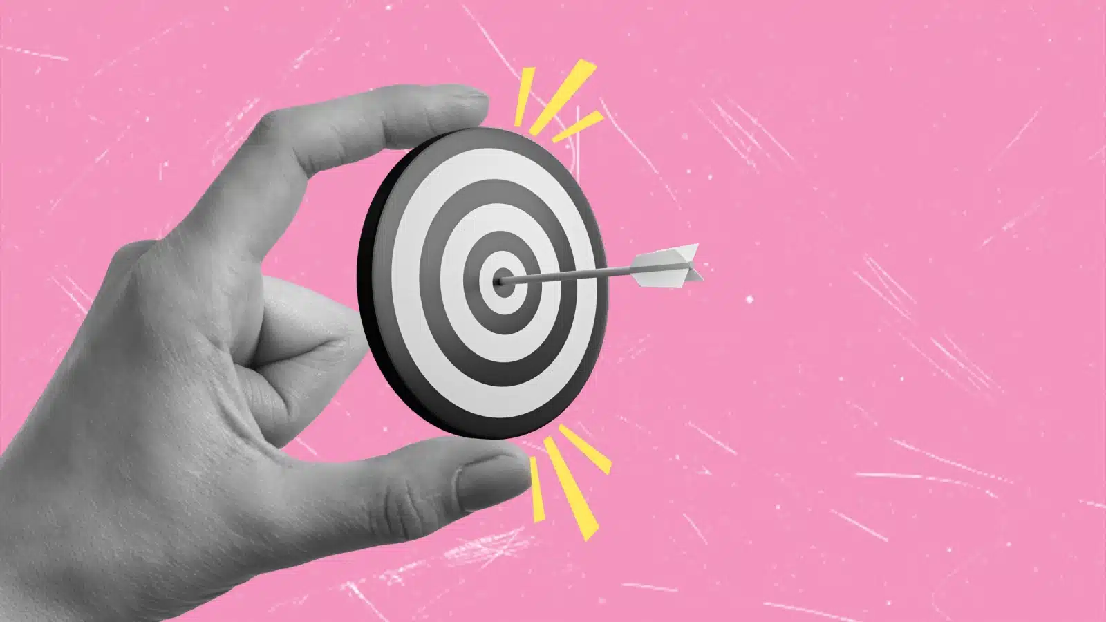 Concept art of a specific goal. A hand holds a mini dart board, with a dart in the exact center.