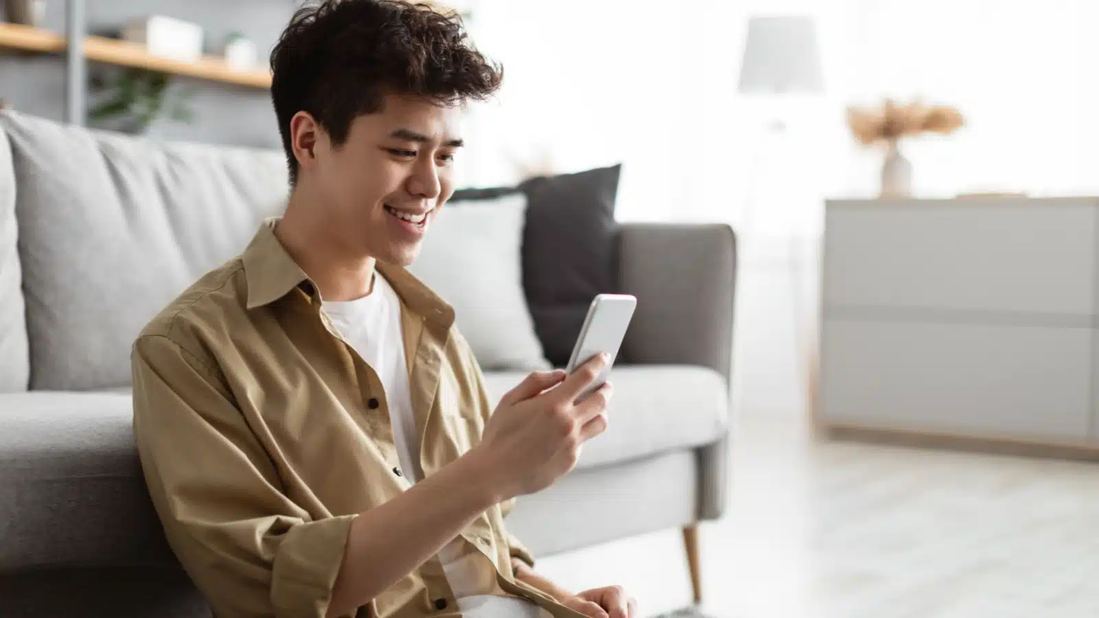 A young man uses an app on his mobile phone.