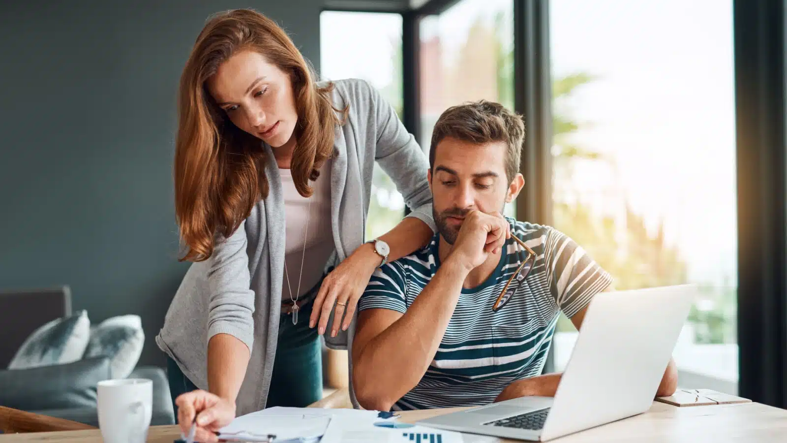 A couple reviews their monthly budget and pays the bills.