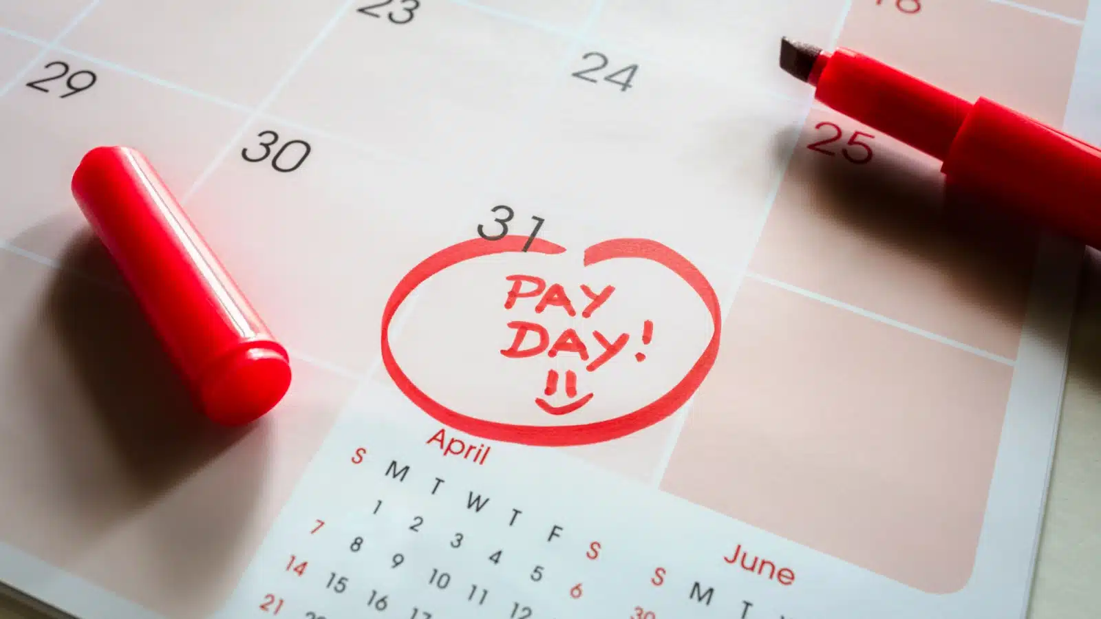 A calendar with the last day of the month circled and marked "pay day!"