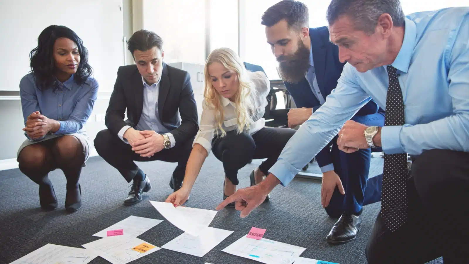 A group of colleagues works together to solve a problem.