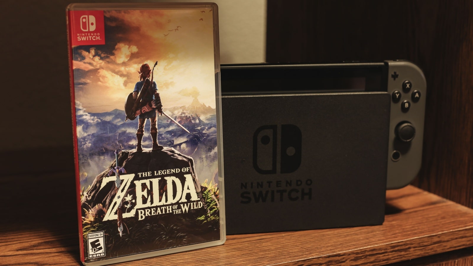 A game case for The Legend of Zelda: Breath of the Wild sits in front of a Nintendo Switch console.
