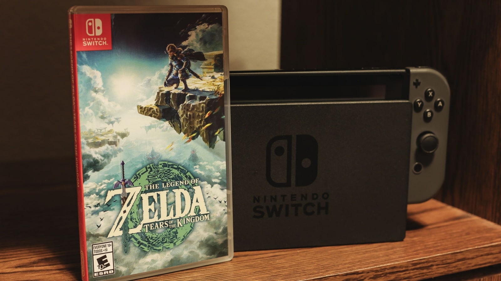 A game case for The Legend of Zelda: Tears of the Kingdom sits in front of a Nintendo Switch console.