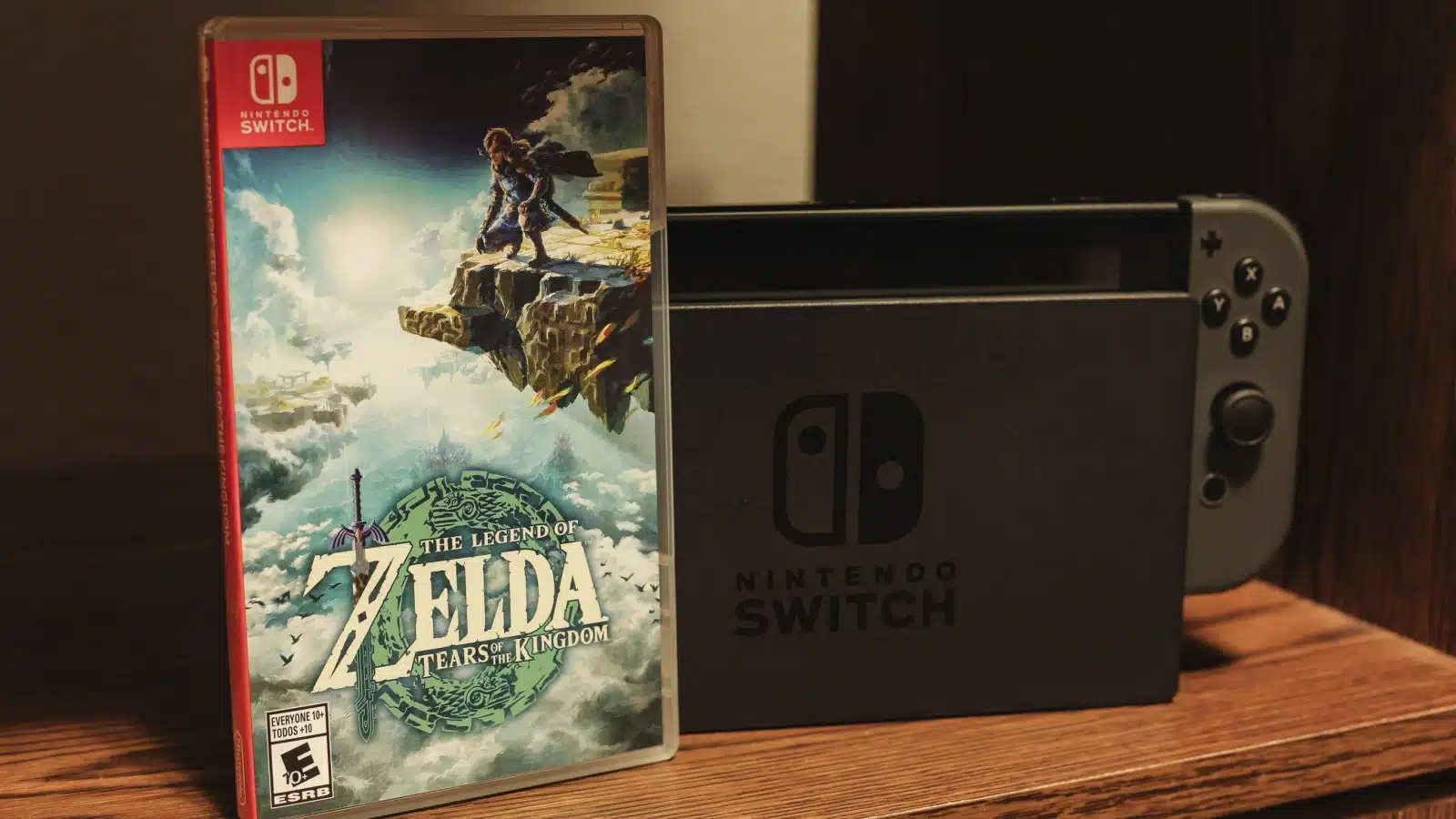 A game case for The Legend of Zelda: Tears of the Kingdom sits in front of a Nintendo Switch console.