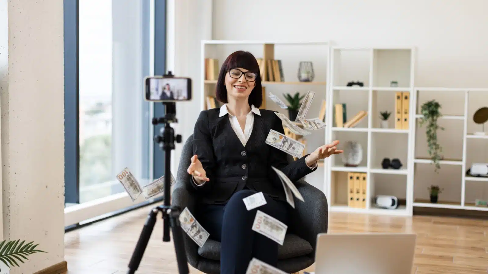 A woman records herself for a podcast while money flies around her. The image represents how to monetize your hobbies.