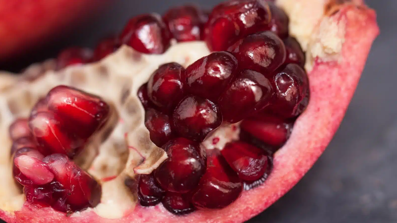 Close up of the seeds in a slice of pomegranate.