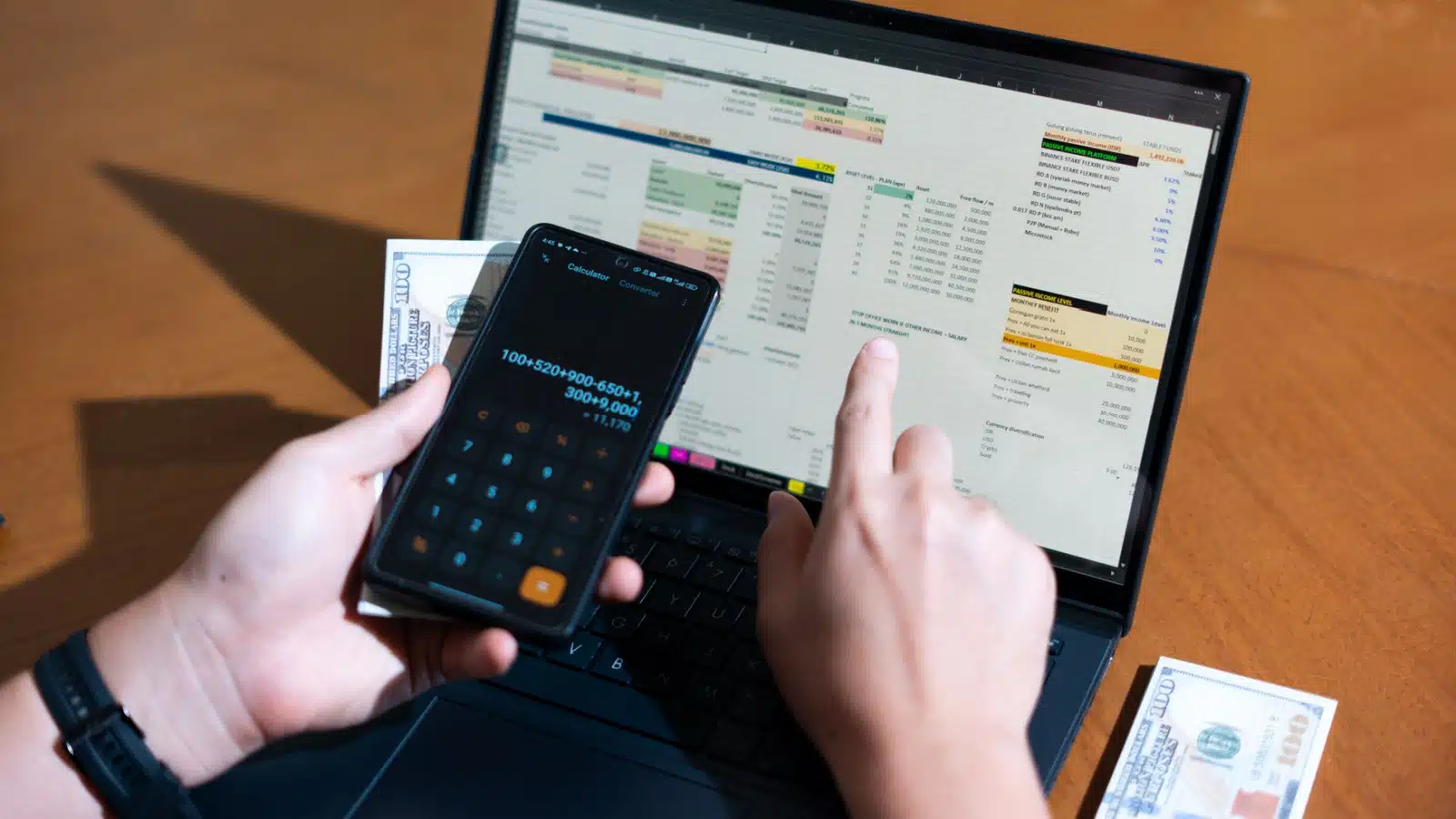A man works on his budget spreadsheet on his laptop.