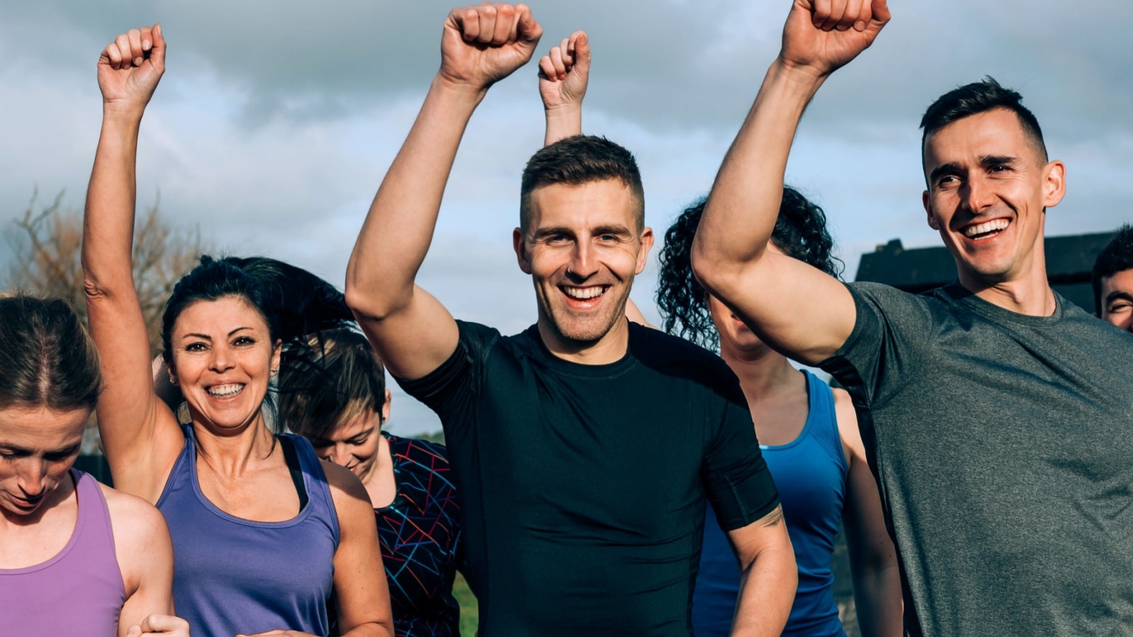 A small group cheers in preparation for running an obstacle course to challenge themselves.