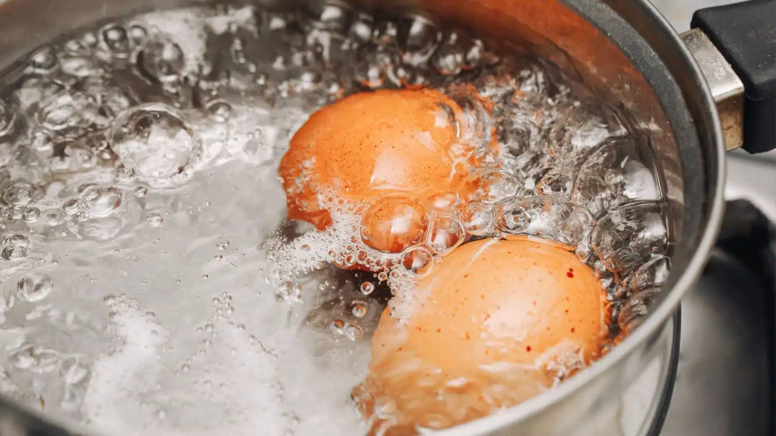 Eggs in boiling water represents how to make hard-boiled eggs.