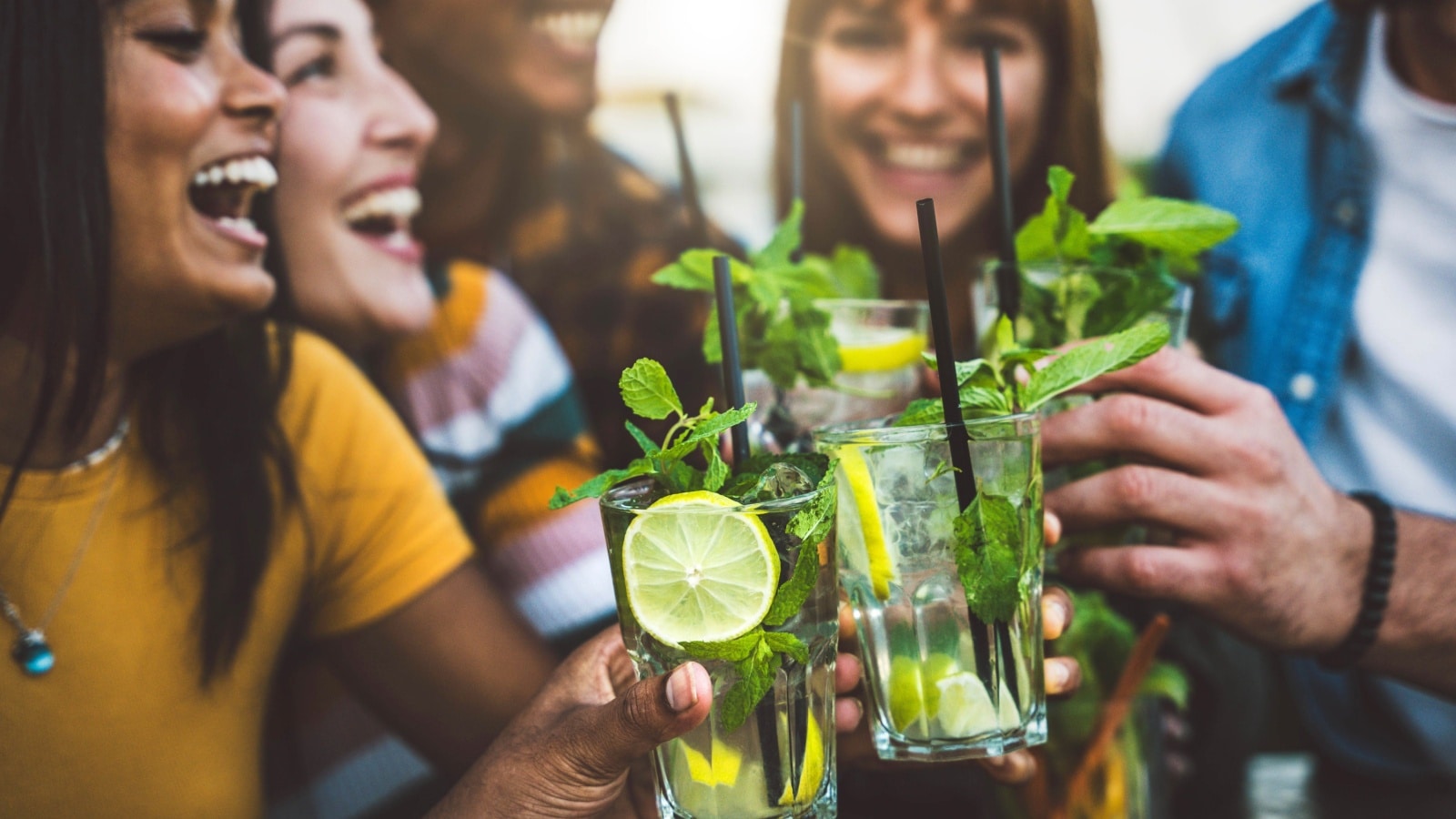 A group of friends enjoy cocktails bursting with spring flavors like lemon and mint.