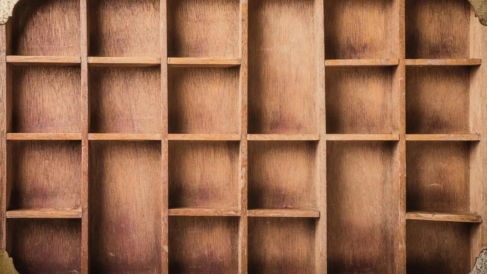 Empty wooden boxes in a shelf.