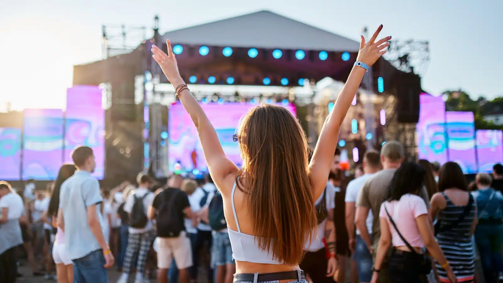 A woman enjoying the show at a music festival.