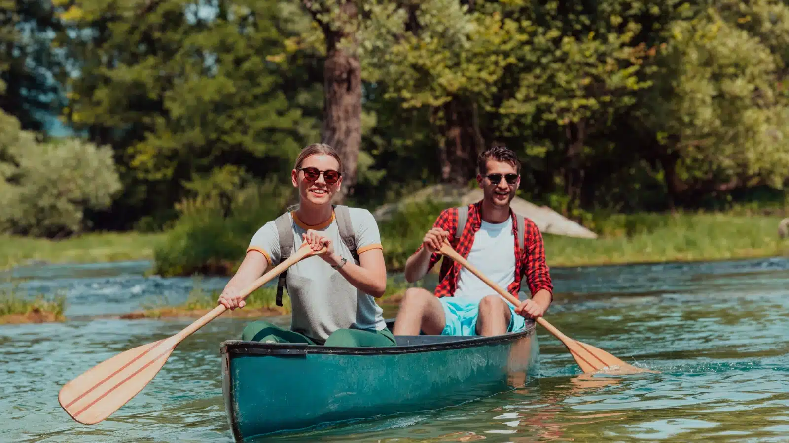 A couple canoeing on a lake.