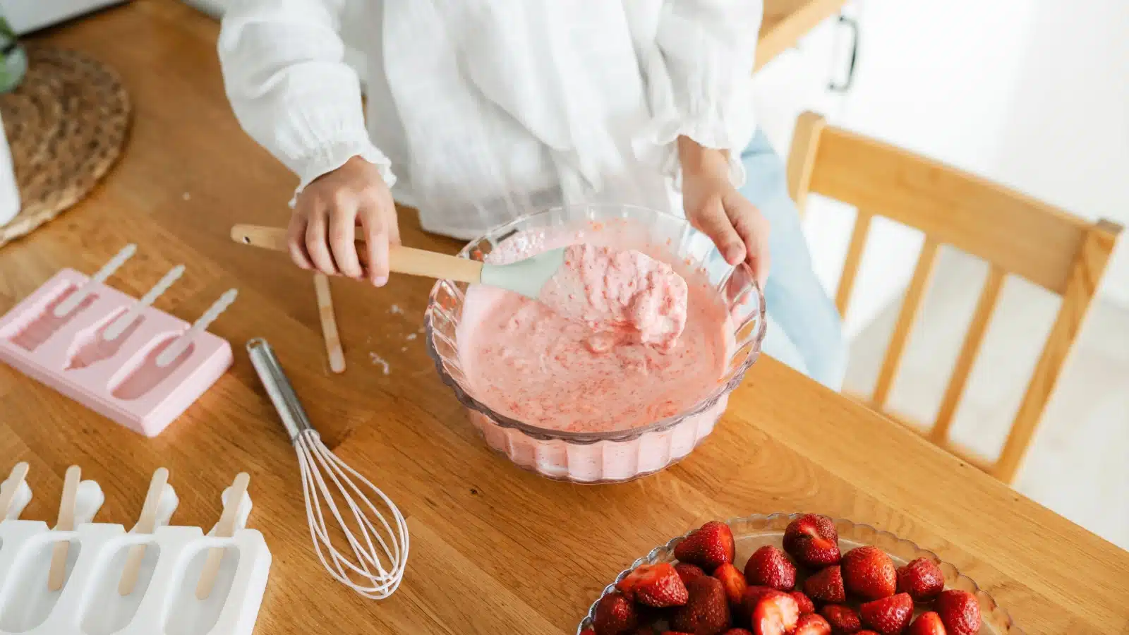 A little girl mixes homemade ice cream.