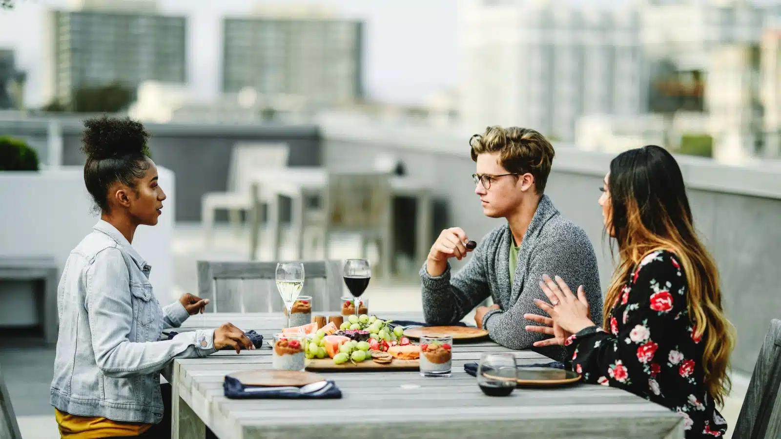 Friends dining at a rooftop restaurant.